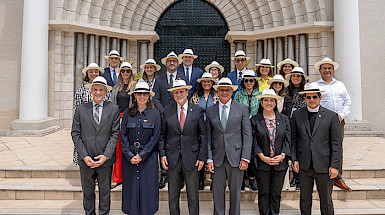 Group photo of HUC member university representatives in front of a historic building during the conference.