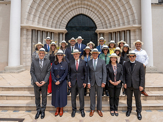 Group photo of HUC member university representatives in front of a historic building during the conference.