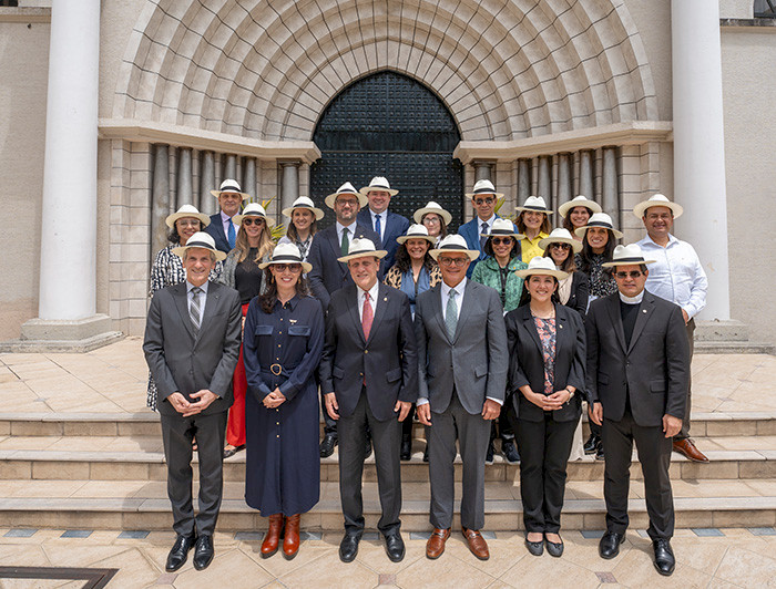 Group photo of HUC member university representatives in front of a historic building during the conference.