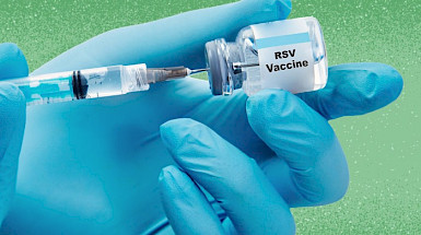 A close-up of a medical professional wearing blue gloves holding a syringe and a small vial labeled RSV Vaccine. The syringe is being filled with liquid from the vial. The background is green with a soft texture, creating a clean and professional medical setting.